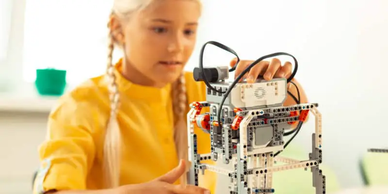 Young girl playing with robotic toy