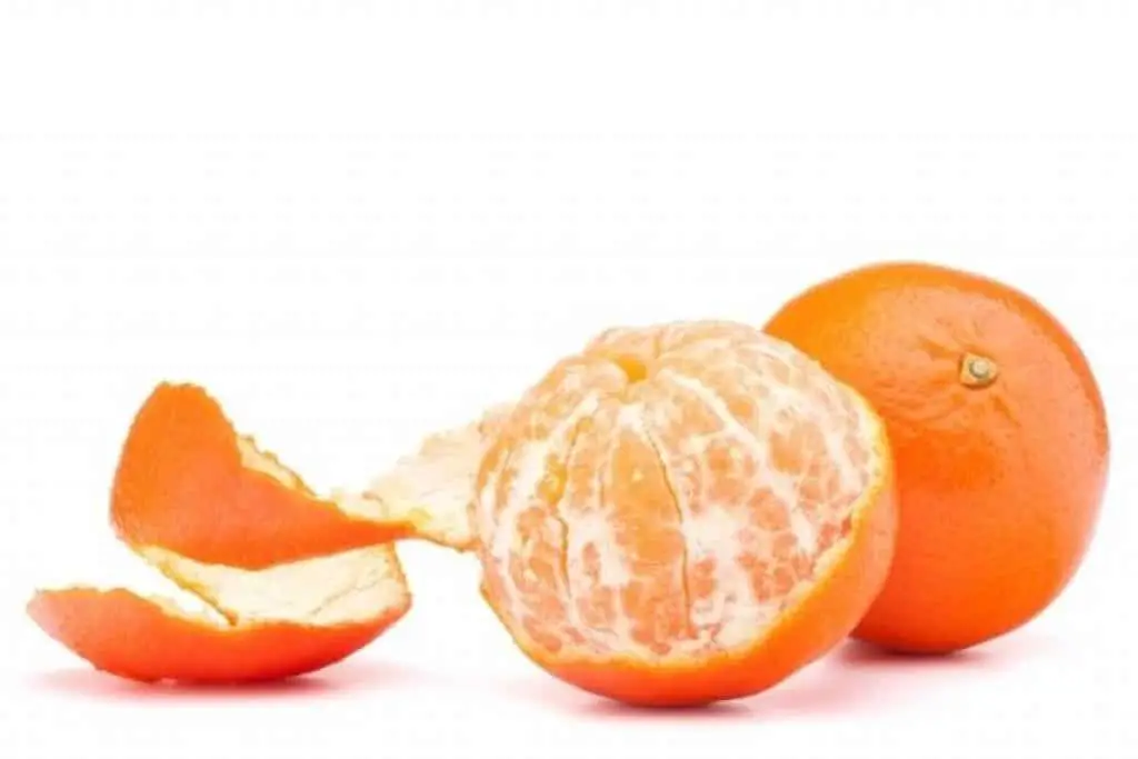 Peeled and unpeeled oranges on white background