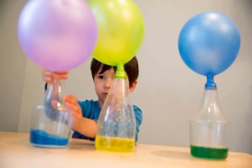 Child doing STEM project with balloons