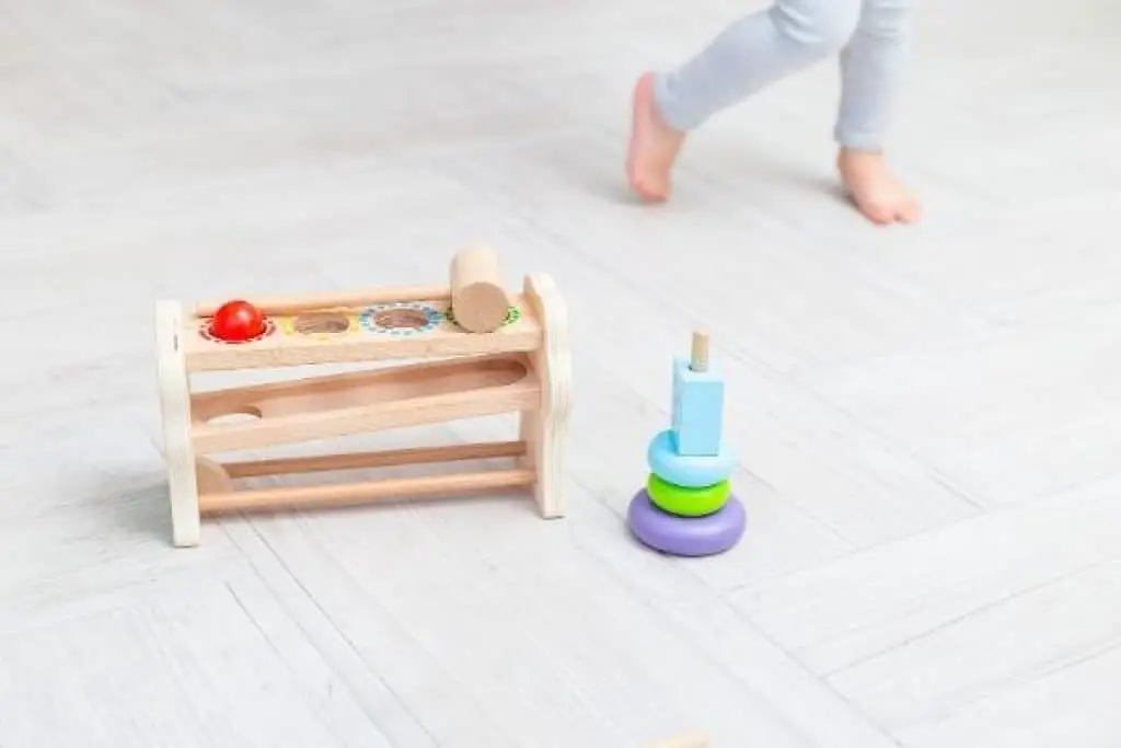 Child standing near wooden STEM toys