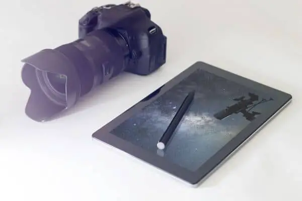A camera and a tablet showing a photo of a telescope for astrophotography
