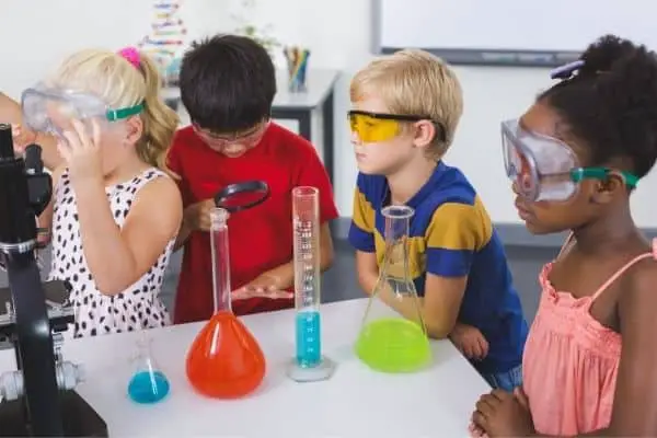 Children listening to instructions for chemistry experiment