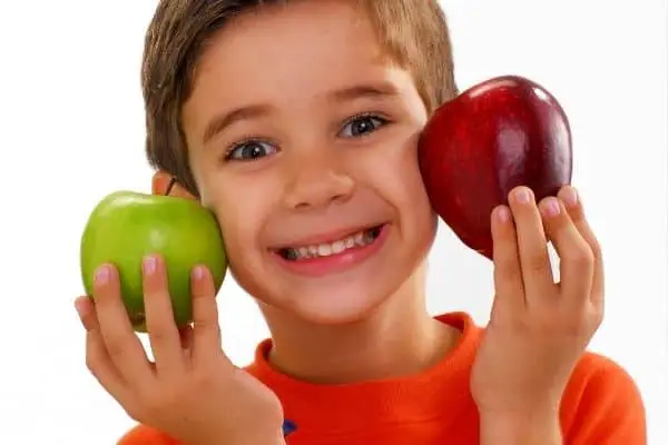 Kid Holding Two Apples For Tooth Decay Science Fair Project