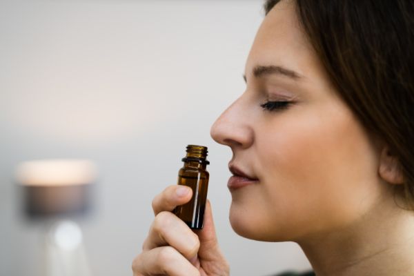 Woman Sniffing Essential Oil
