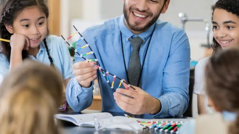 Man Showing A Dna Model To Kids In Classroom