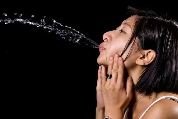 Woman Spitting Out Water